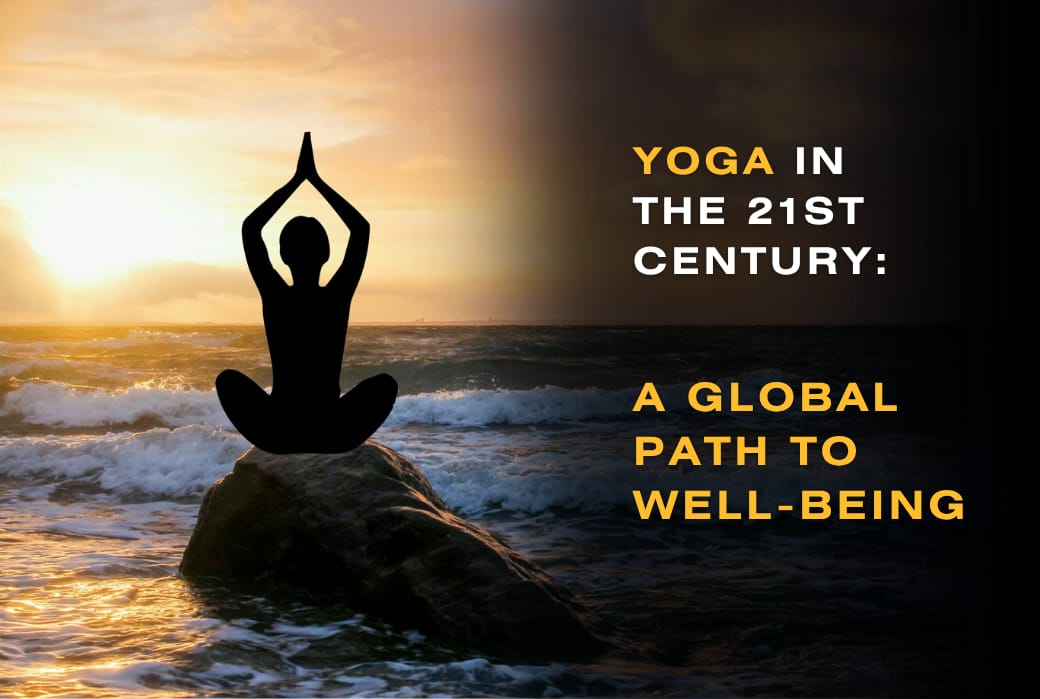 Silhouette of a person in a yoga pose on a rock by the ocean at sunset, representing yoga in the 21st century as a global path to well-being